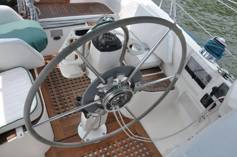 Slide: The Image of 1986 Scanmar 33 sailboat cockpit with steering wheel and navigation instruments. - 13