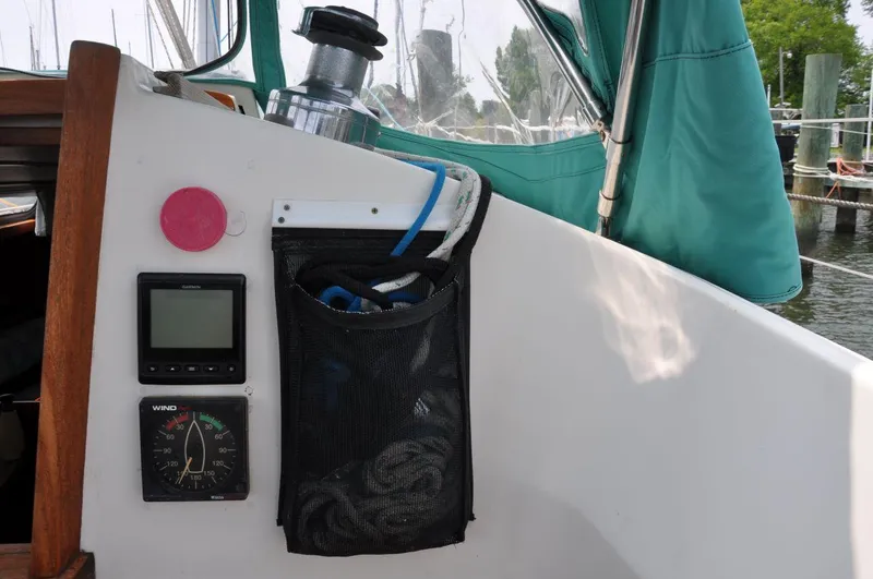 Slide: The Image of Cockpit of 1986 Scanmar 33 sailboat with navigation instruments and storage net. - 14