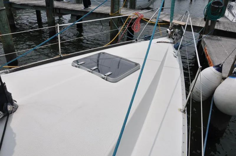 Slide: The Image of 1986 Scanmar 33 sailboat deck with hatch, docked at marina. - 9