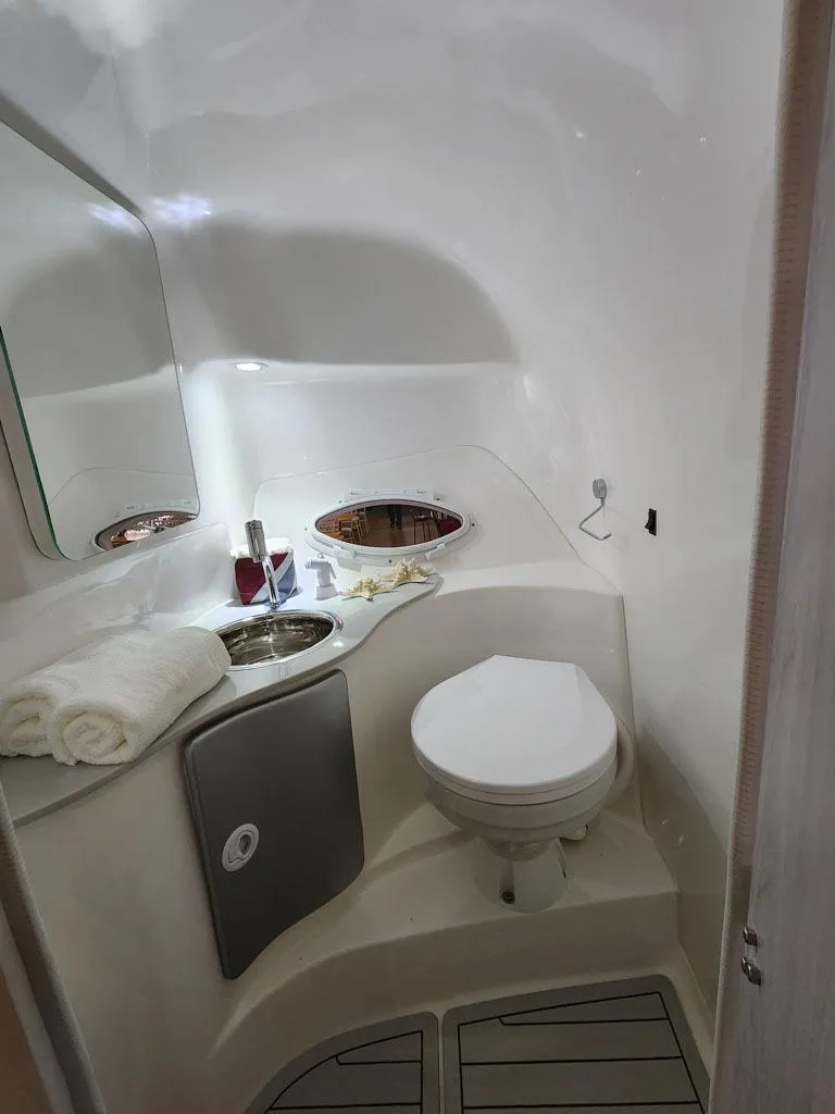 Slide: The Image of Compact bathroom in 2025 Hanover 305 Inboard boat with toilet, sink, and mirror. - 12