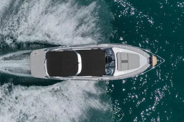 Slide: The Image of Aerial view of 2025 Hanover 305 Inboard boat cruising on clear blue water. - 4