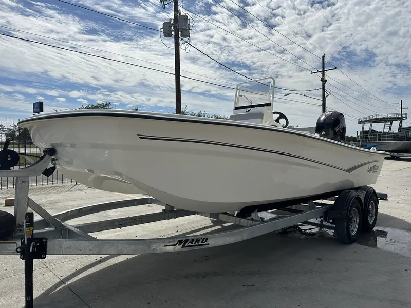 Slide: The Image of 2024 Mako Pro Skiff 19 CC boat on trailer under cloudy sky. - 5