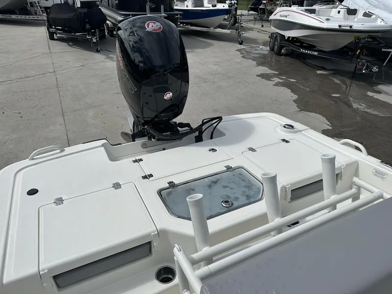 Slide: The Image of 2024 Mako Pro Skiff 19 CC boat with outboard motor, docked on concrete surface. - 7