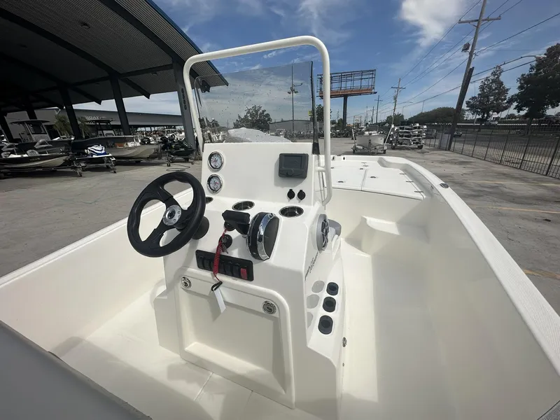 Slide: The Image of 2024 Mako Pro Skiff 19 CC boat interior with steering console and gauges. - 8