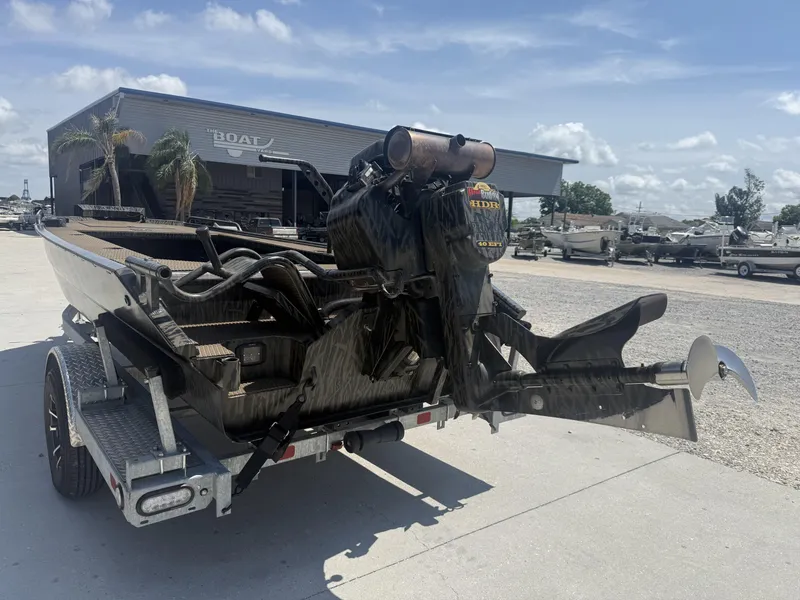 Slide: The Image of 2024 Prodigy 17x51 boat on trailer, parked outside a boat yard under a clear sky. - 10