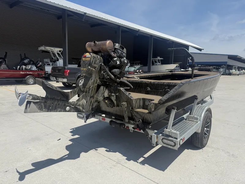 Slide: The Image of 2024 Prodigy 17x51 boat on trailer, parked outdoors near a storage facility. - 6