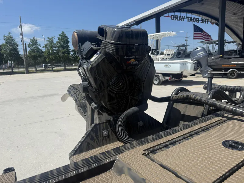 Slide: The Image of 2024 Prodigy 17x51 boat with camo design and powerful engine, displayed outdoors. - 8