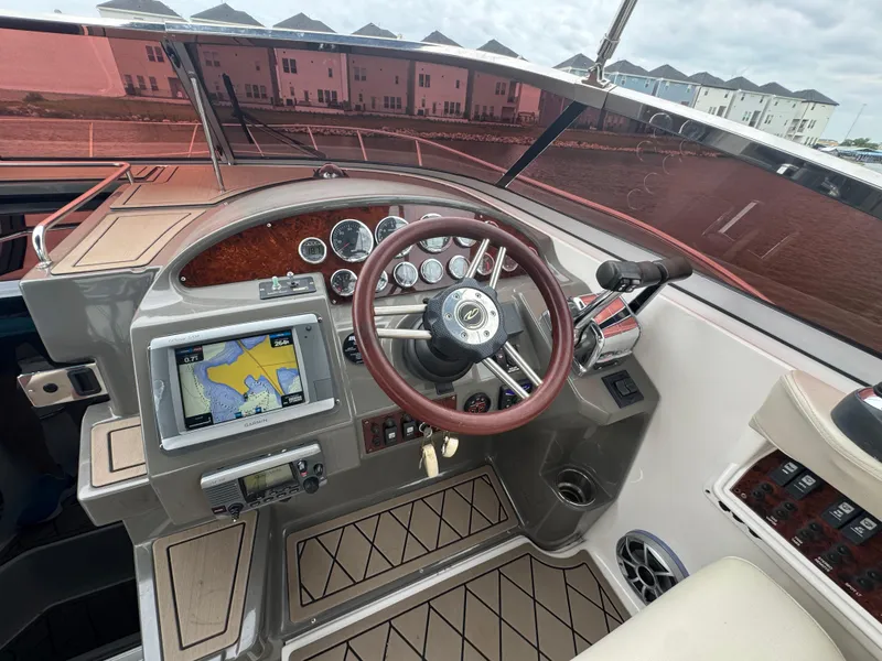 Slide: The Image of 2011 Regal 35 Express Cruiser helm with GPS, gauges, and wood accents. - 18