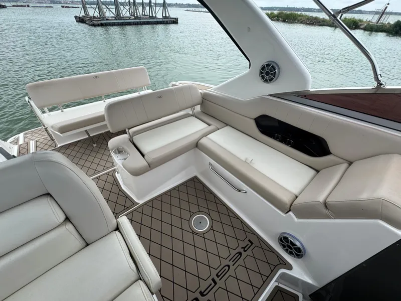 Slide: The Image of Luxurious seating area on a 2011 Regal 35 Express Cruiser yacht, overlooking serene waters. - 19