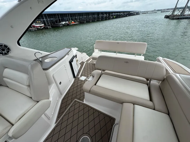 Slide: The Image of 2011 Regal 35 Express Cruiser interior with beige seating, docked by the water. - 20