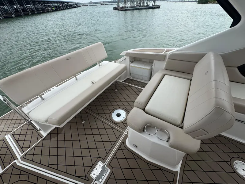 Slide: The Image of 2011 Regal 35 Express Cruiser interior with beige seating and water view. - 22