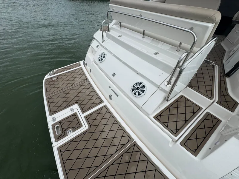 Slide: The Image of 2011 Regal 35 Express Cruiser boat deck with speakers and cushioned seating. - 26