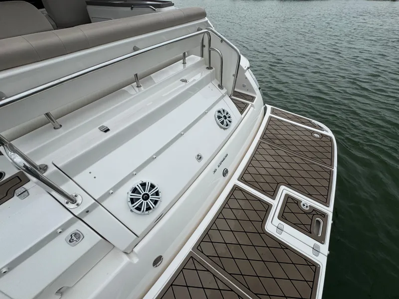 Slide: The Image of 2011 Regal 35 Express Cruiser swim platform with speakers and teak-style decking. - 27