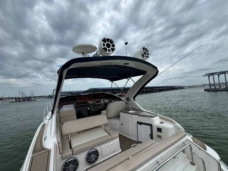 Slide: The Image of 2011 Regal 35 Express Cruiser on water, featuring spacious seating and modern amenities. - 28