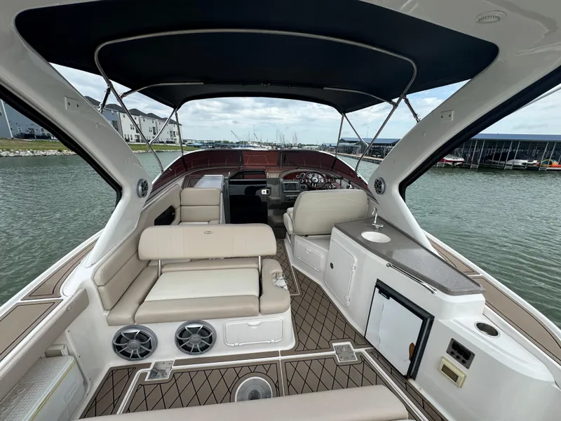 Slide: The Image of 2011 Regal 35 Express Cruiser interior with seating, helm, and water view. - 29