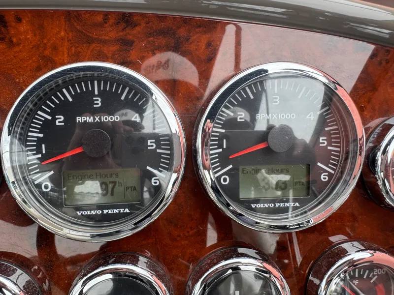 Slide: The Image of Dashboard gauges of a 2011 Regal 35 Express Cruiser boat, showing RPM and engine hours. - 31