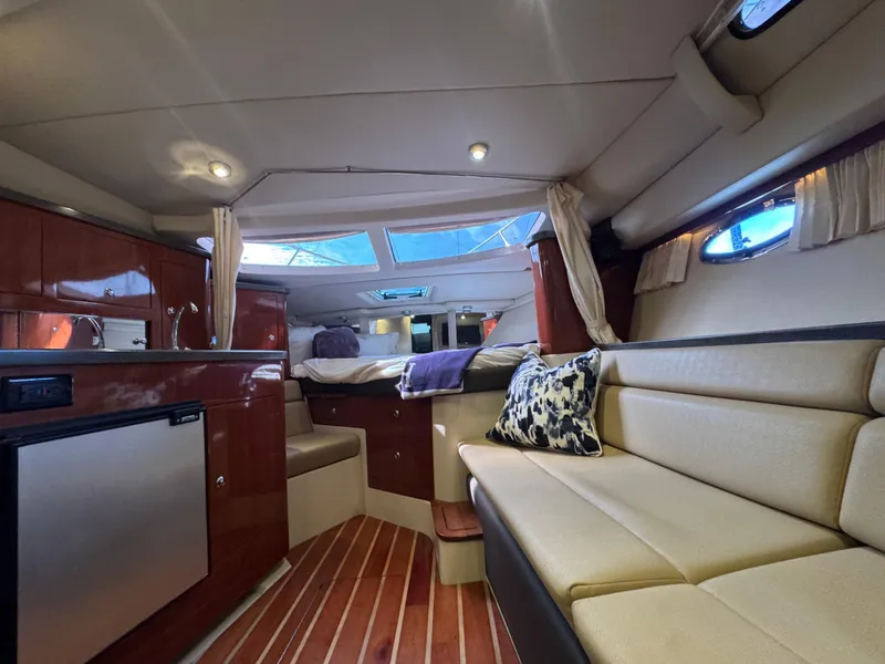 Slide: The Image of Interior of 2011 Regal 35 Express Cruiser with seating, kitchenette, and bed. - 34
