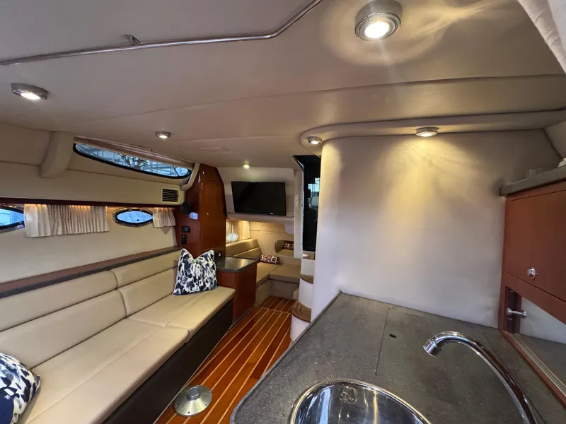 Slide: The Image of Interior of 2011 Regal 35 Express Cruiser with modern seating and kitchenette. - 37