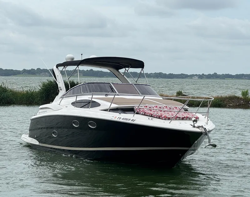 Slide: The Image of 2011 Regal 35 Express Cruiser on a calm lake under cloudy skies. - 4