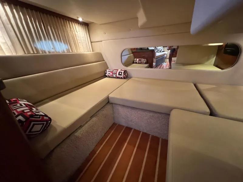 Slide: The Image of Interior of 2011 Regal 35 Express Cruiser with beige seating and decorative pillows. - 41