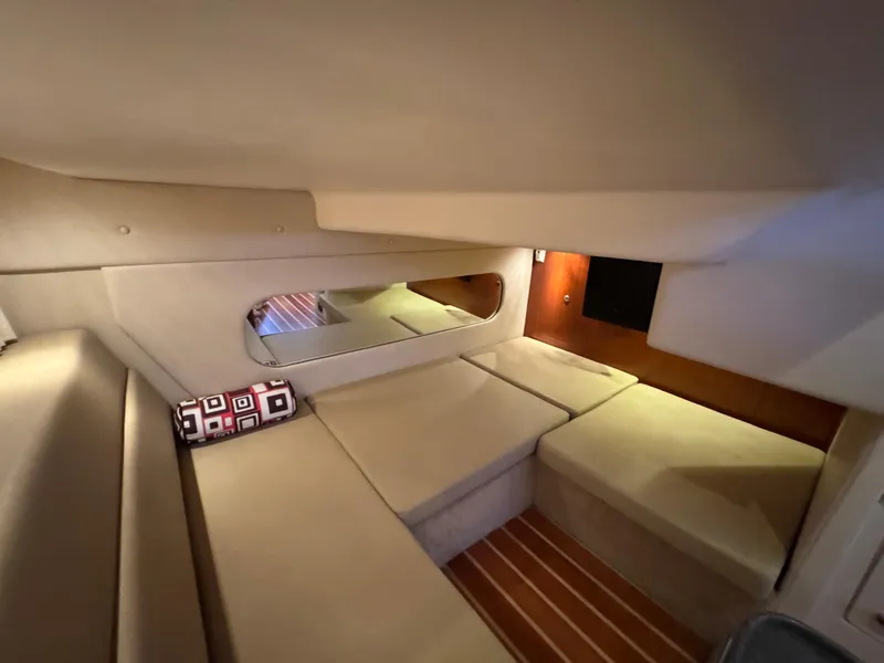 Slide: The Image of Interior cabin of 2011 Regal 35 Express Cruiser with beige seating and wood accents. - 42