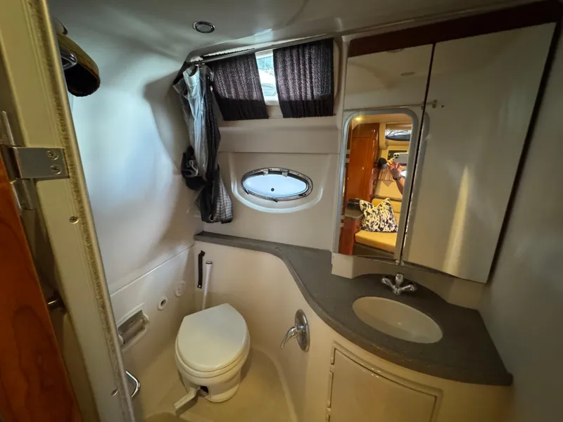 Slide: The Image of Bathroom interior of 2011 Regal 35 Express Cruiser with sink, toilet, and mirror. - 43
