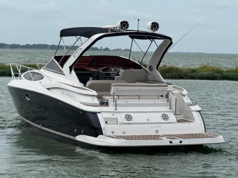 Slide: The Image of 2011 Regal 35 Express Cruiser on water, rear view, black and white design. - 8