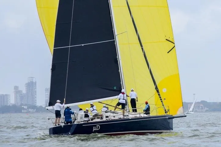 Slide: The Image of Sailing yacht J/124 from 2005 with vibrant yellow and black sails on open water. - 0