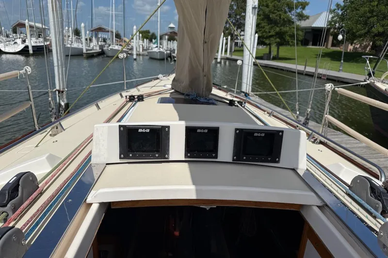 Slide: The Image of 2005 J Boats J/124 sailboat cockpit with navigation instruments, docked at a marina. - 11