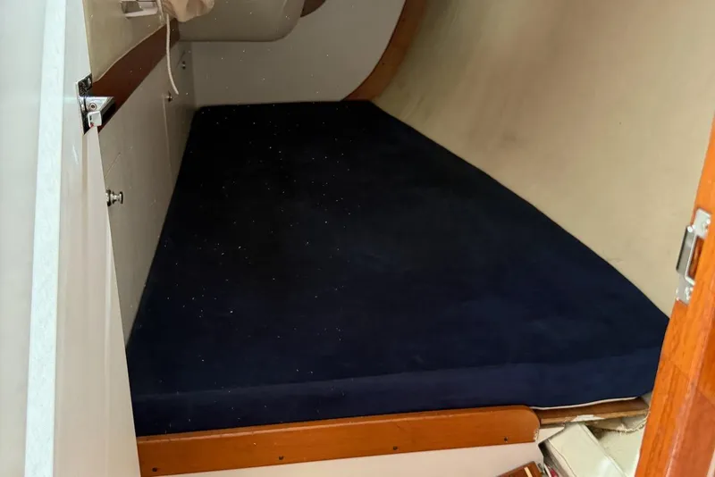 Slide: The Image of 2005 J Boats J/124 cabin interior with dark blue mattress. - 17
