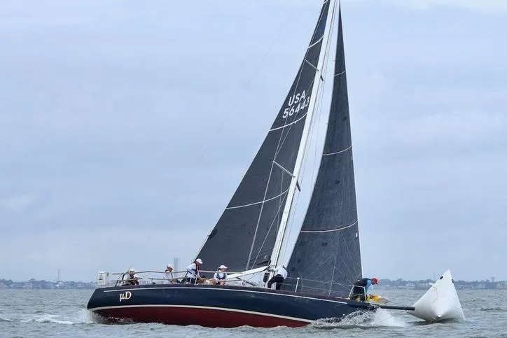 Slide: The Image of 2005 J Boats J/124 sailing on open water with crew, overcast sky. - 2