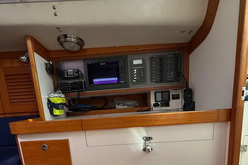Slide: The Image of Navigation station of a 2005 J Boats J/124 sailboat with control panels and equipment. - 20