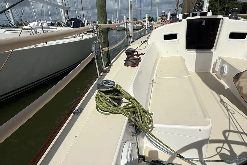 Slide: The Image of 2005 J Boats J/124 sailboat deck with ropes and winch in marina. - 23