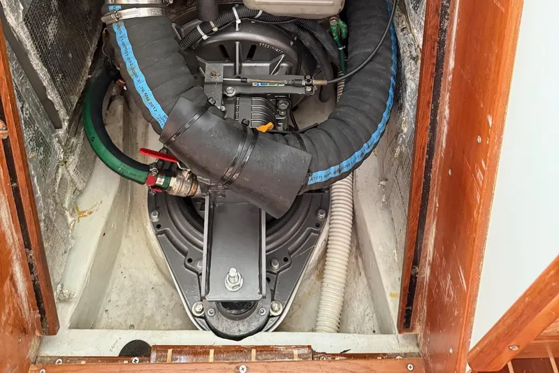 Slide: The Image of Engine compartment of a 2005 J Boats J/124 sailboat, featuring hoses and mechanical components. - 25