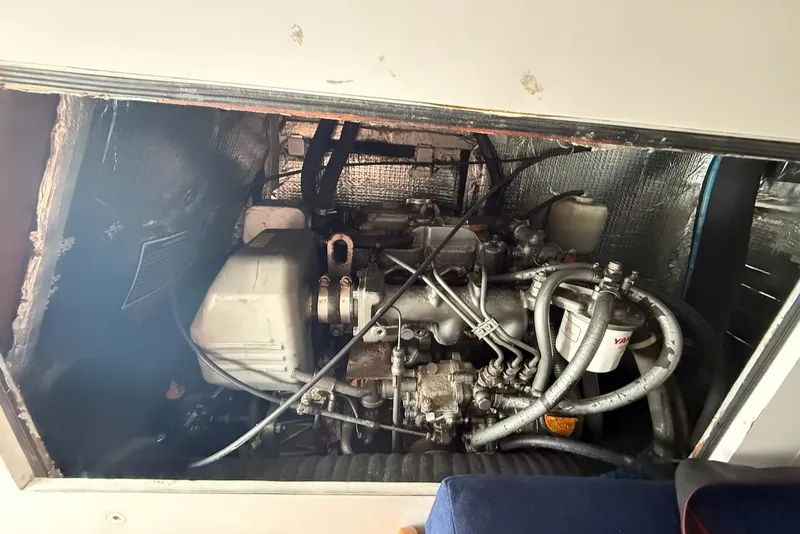 Slide: The Image of Engine compartment of a 2005 J Boats J/124 sailboat, showcasing mechanical components and wiring. - 26