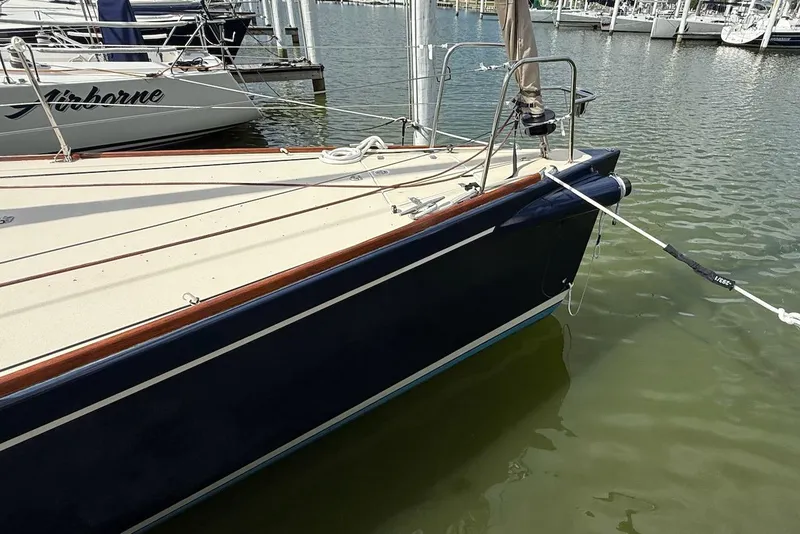 Slide: The Image of 2005 J Boats J/124 docked, showing sleek blue hull and deck details. - 7