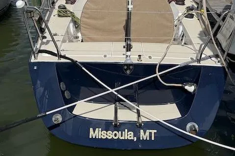 Slide: The Image of 2005 J Boats J/124 sailboat docked, stern view, labeled "Missoula, MT." - 9