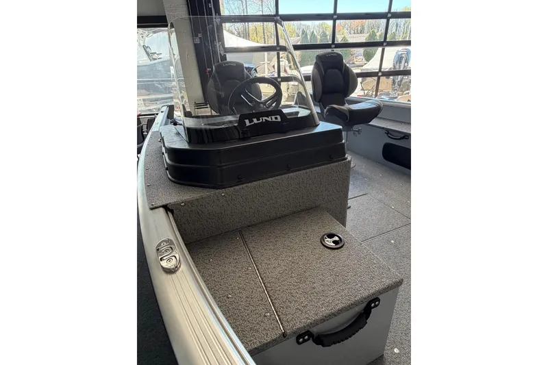 Slide: The Image of 2025 Lund 1675 Alaskan SS boat interior with steering console and seating. - 10