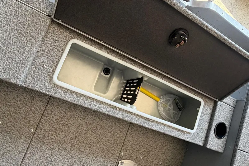 Slide: The Image of Open storage compartment in 2025 Lund 1675 Alaskan SS boat with fishing gear. - 12