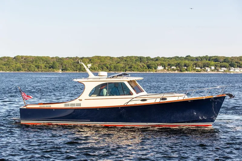 Slide: The Image of 2018 Hinckley Picnic Boat 37 MKIII cruising on a calm lake. - 11