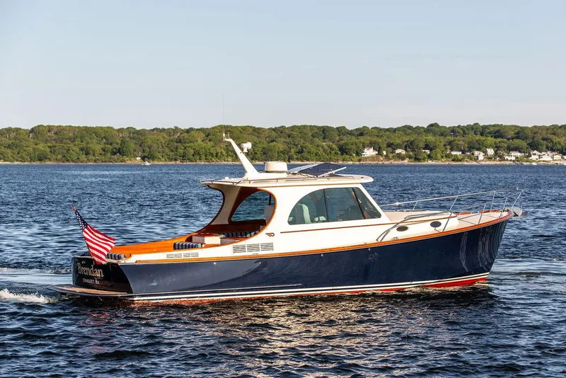 Slide: The Image of 2018 Hinckley Picnic Boat 37 MKIII cruising on open water. - 14