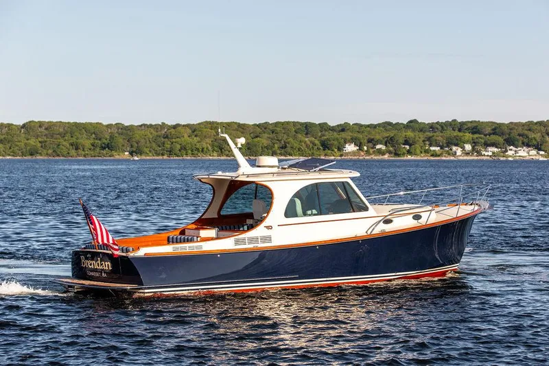Slide: The Image of 2018 Hinckley Picnic Boat 37 MKIII cruising on a serene lake. - 15
