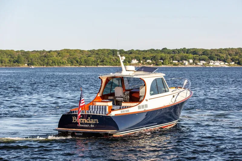 Slide: The Image of 2018 Hinckley Picnic Boat 37 MKIII cruising on a scenic lake. - 17