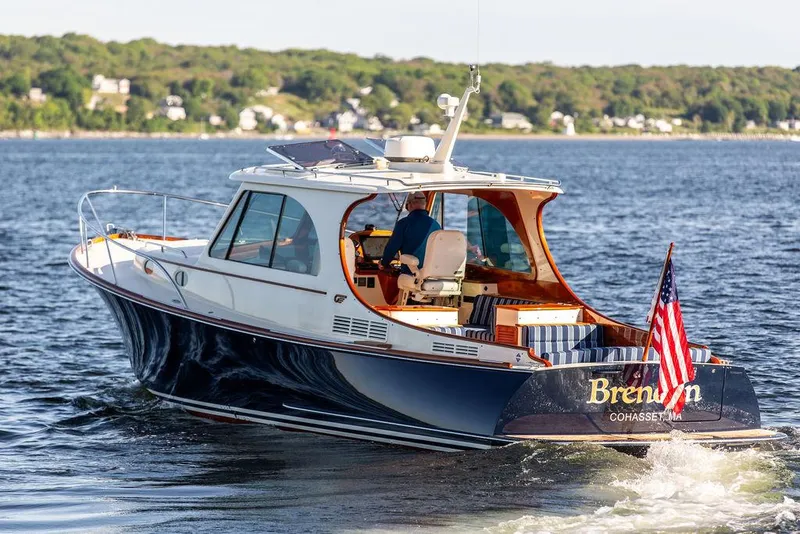 Slide: The Image of 2018 Hinckley Picnic Boat 37 MKIII cruising on water with American flag. - 20