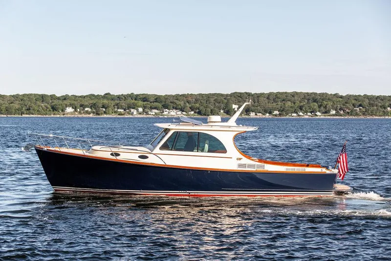 Slide: The Image of 2018 Hinckley Picnic Boat 37 MKIII cruising on open water. - 21