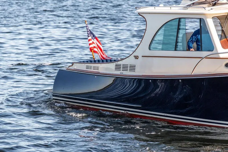 Slide: The Image of 2018 Hinckley Picnic Boat 37 MKIII cruising on water with American flag. - 22