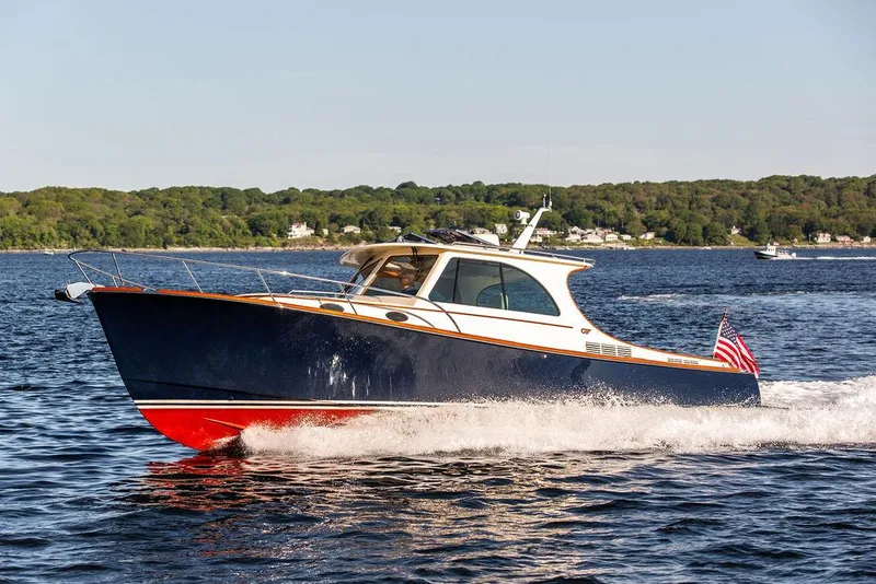 Slide: The Image of 2018 Hinckley Picnic Boat 37 MKIII cruising on a scenic lake. - 23