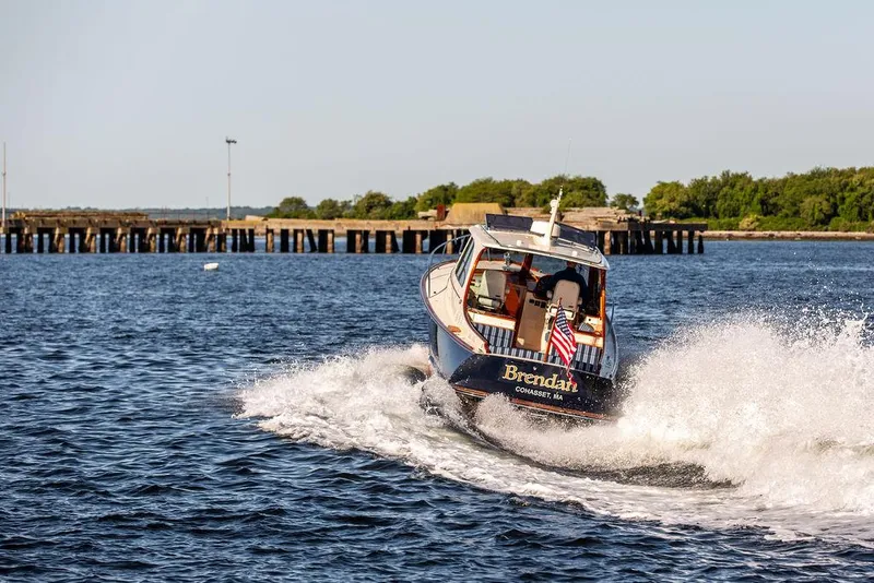 Slide: The Image of Hinckley Picnic Boat 37 MKIII cruising on water, 2018 model, with American flag. - 24