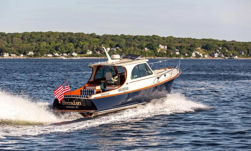 Slide: The Image of 2018 Hinckley Picnic Boat 37 MKIII cruising on open water, American flag displayed. - 25