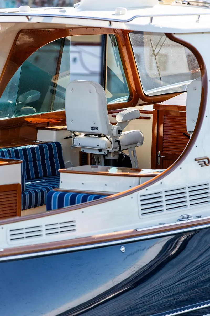 Slide: The Image of 2018 Hinckley Picnic Boat 37 MKIII interior with striped seating and helm chair. - 28